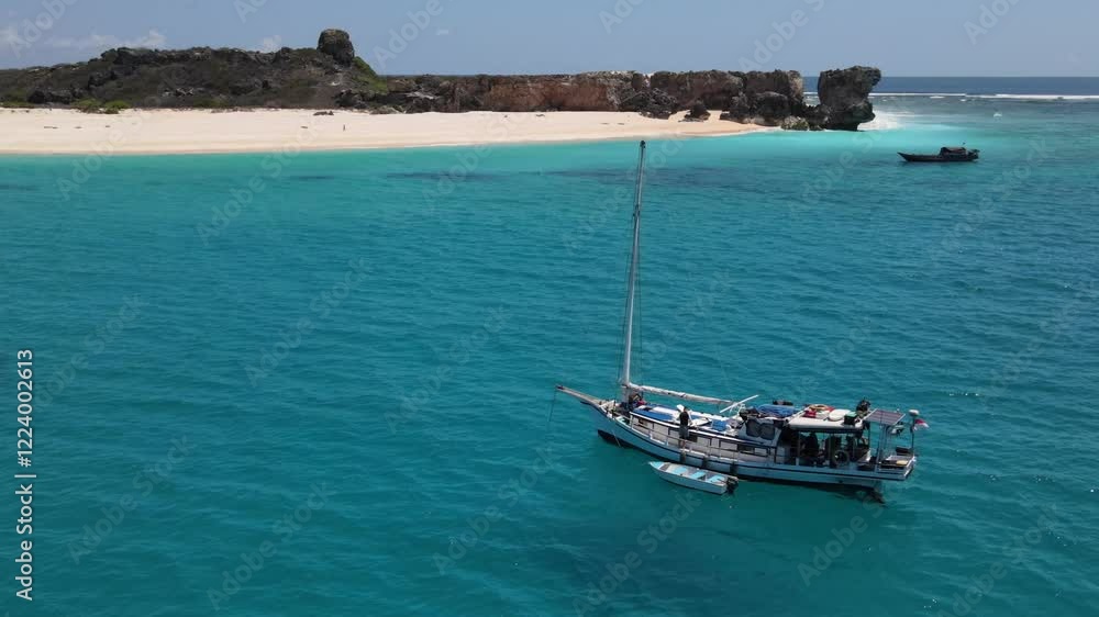 Aerial view of a small wooden yacht standing in a Marina near a desert island. Aerial view of a small wooden yacht standing in a Marina near a desert island.