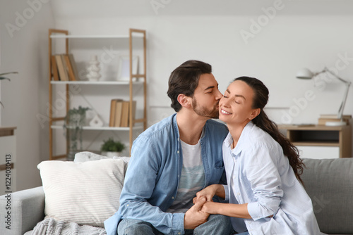 Happy husband kissing his w...