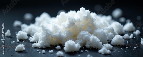 Soft white fluffy material scattered on a dark background, soft polyester fluff, white pilling material photo