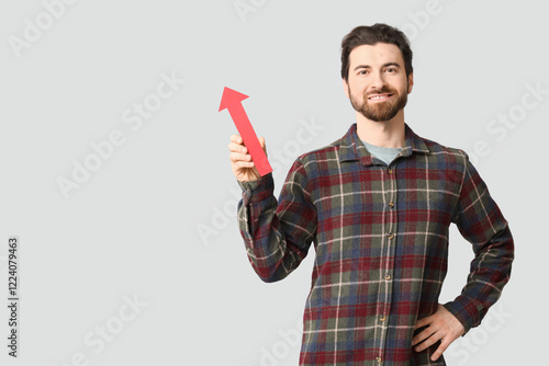 Young man with arrow pointi...