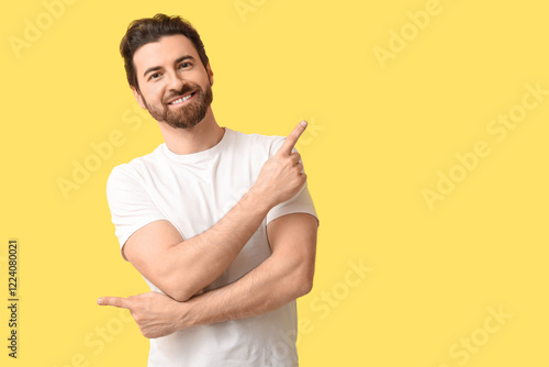 Young man pointing at somet...