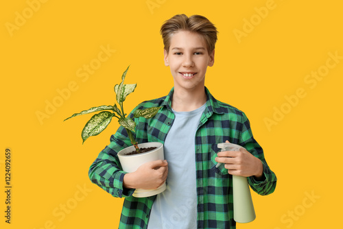 Teenage boy with plant and ...