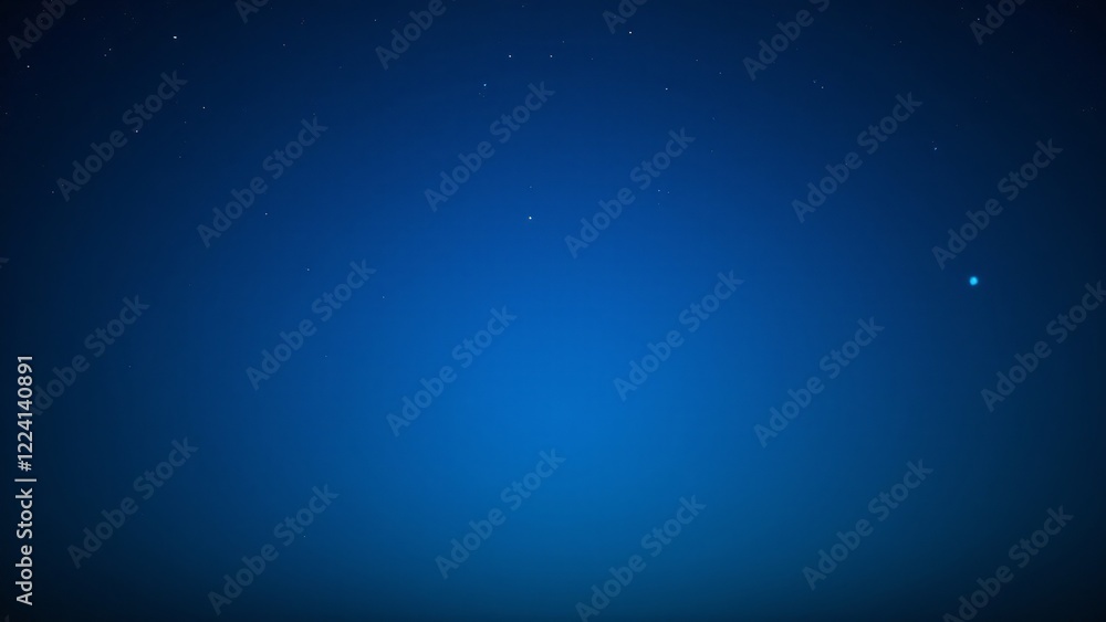 Fototapeta premium A peaceful night sky with a subtle blue glow caused by atmospheric light scattering, highlighting the stars.