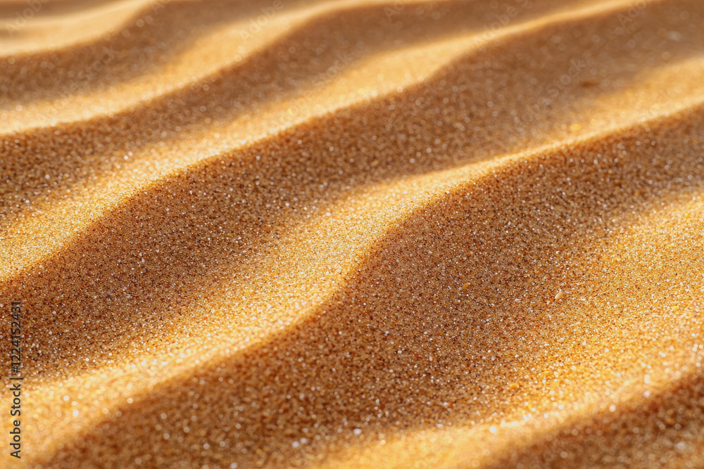 Naklejka premium Close up view of fine sand texture background with natural patterns and variations in color and grain size for use in design and art projects