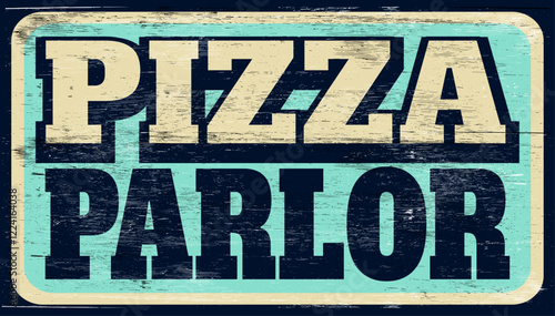 Aged and worn pizza parlor sign on wood