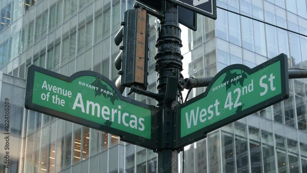 New York City crossroad, 42 street intersection green road sign. 6 Sixth ave, Americas avenue corner, Midtown business district, NYC, Bryant park. Highrise skyscraper architecture, text roadsign. New York City crossroad, 42 street intersection green road sign. 6 Sixth ave, Americas avenue corner, Midtown business district, NYC, Bryant park. Highrise skyscraper architecture, text roadsign.