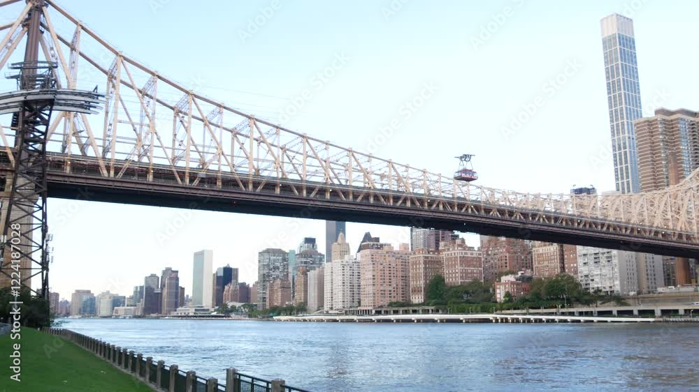 New York City waterfront skyline, Queensboro Bridge, Manhattan Midtown buildings, riverfront skyscrapers. Waterside cityscape view from Roosevelt Island. United States architecture and real estate.