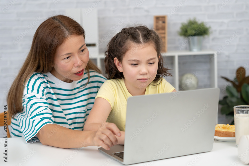 online tutor online course for Asian children. video conference on laptop at home. play back online course, girl student wear earphones to study, notes homework, video classes, new education.. online tutor online course for Asian children. video conference on laptop at home. play back online course, girl student wear earphones to study, notes homework, video classes, new education..