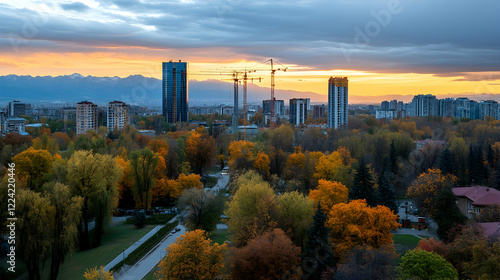 Wallpaper Mural Autumn city skyline at sunset, construction cranes visible, park in foreground.  Use Cityscape, real estate Torontodigital.ca