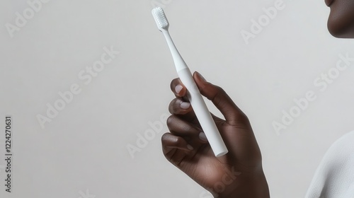 Adult Brushing Teeth with Sleek Toothbrush photo