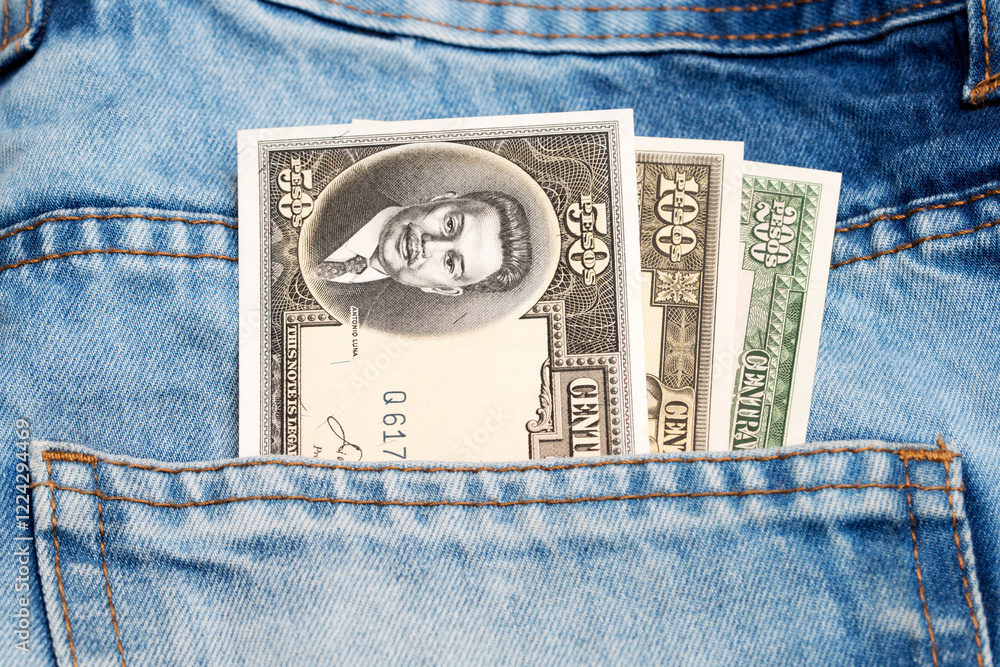Old Philippine peso in the pocket of blue jeans Old Philippine peso in the pocket of blue jeans