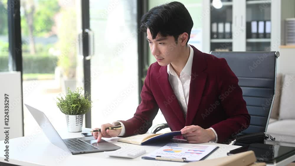 Young Businessman using laptop and tablet while sitting at her working place Young Businessman using laptop and tablet while sitting at her working place