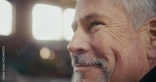Extreme close up on the smiling eyes of a man in abandoned factory.