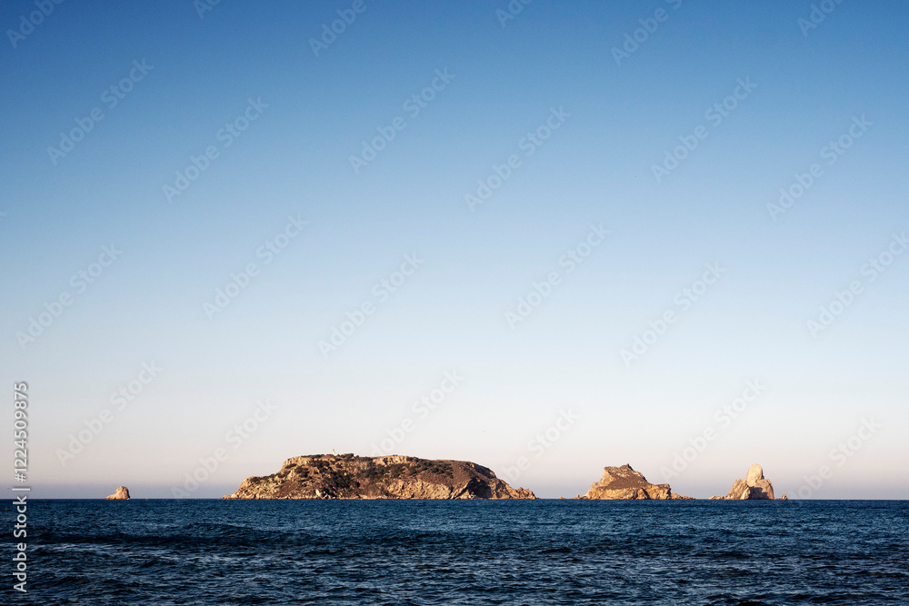 beautiful seascape with Medas islands in the middle of the sea with clear sky and sunlight shining bright, concept of peaceful and serene landscape, copyspace for text beautiful seascape with Medas islands in the middle of the sea with clear sky and sunlight shining bright, concept of peaceful and serene landscape, copyspace for text
