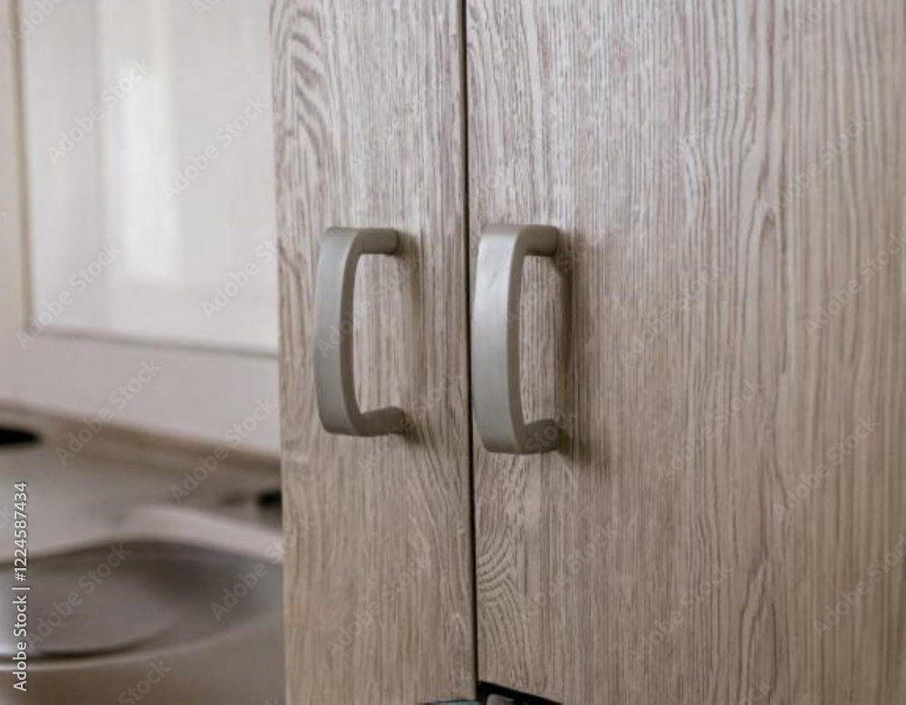 Close-Up of Stylish Light Gray Cabinet Handles in Modern Scandinavian Kitchen Interior Close-Up of Stylish Light Gray Cabinet Handles in Modern Scandinavian Kitchen Interior