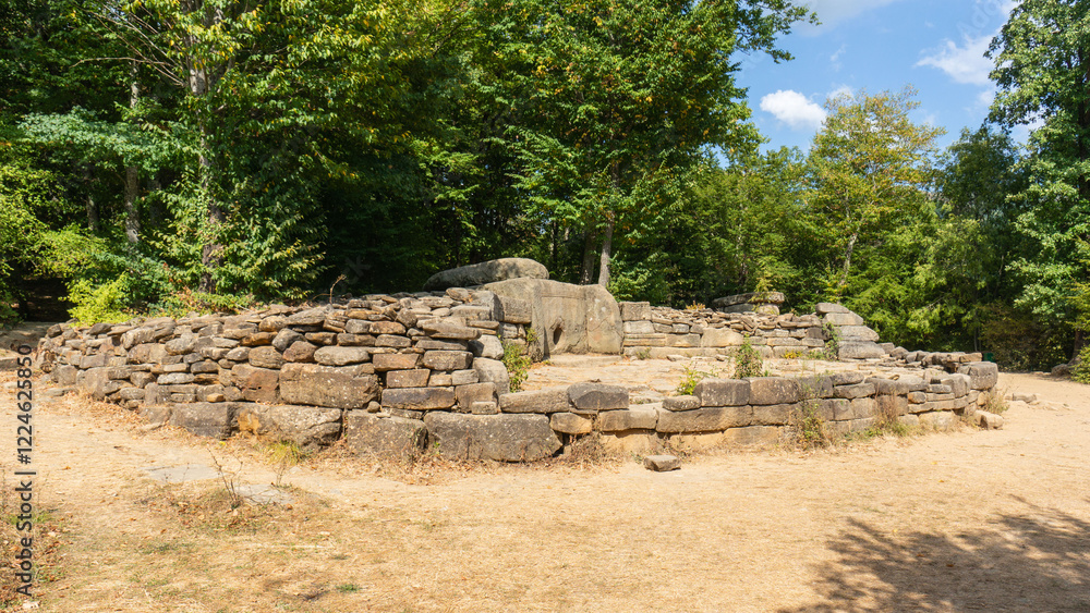 Archaeological site of dolmen or ancient burial and cult structure is located in the forest. Stone structure consists of large, carefully stacked stones with round hole in center. Gelendzhik 2014 Archaeological site of dolmen or ancient burial and cult structure is located in the forest. Stone structure consists of large, carefully stacked stones with round hole in center. Gelendzhik 2014