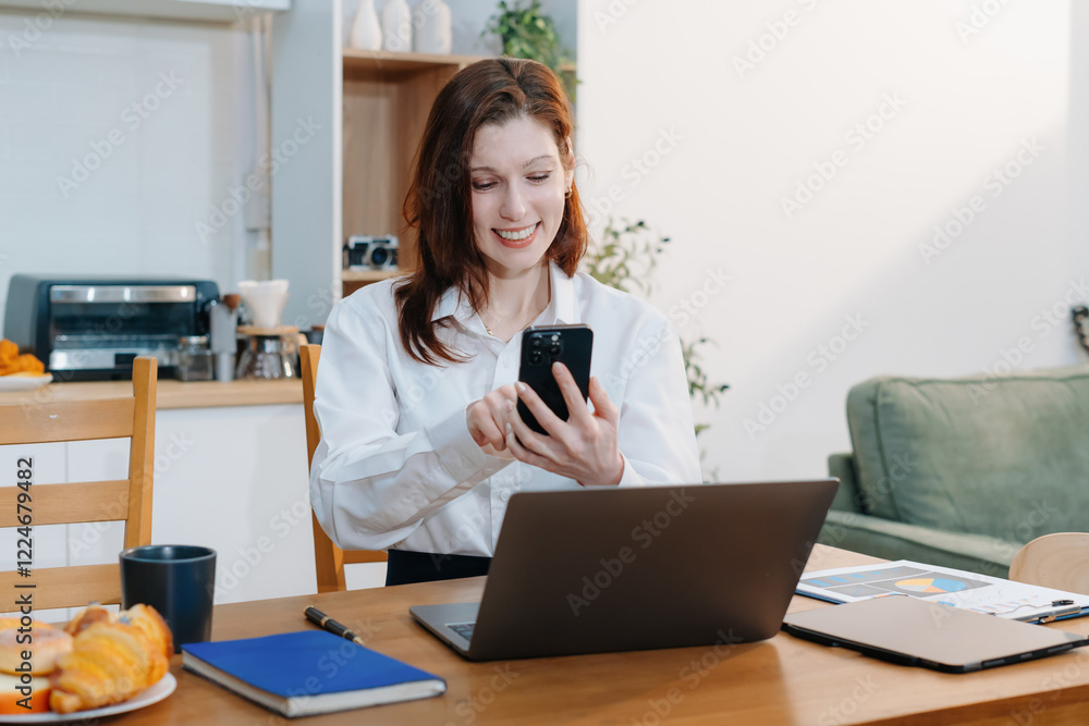 Caucasian businesswoman involved in cellphone call conversation giving professional consultation to client or negotiating project sitting in the kitchen. Caucasian businesswoman involved in cellphone call conversation giving professional consultation to client or negotiating project sitting in the kitchen.