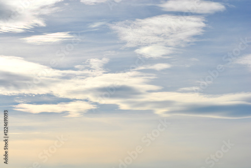 Billede på lærred Layered altostratus clouds with shades of gray and white covering most of the sk