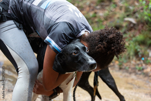 Konstfotografi A mushing runner hugs her dog at the end of the race