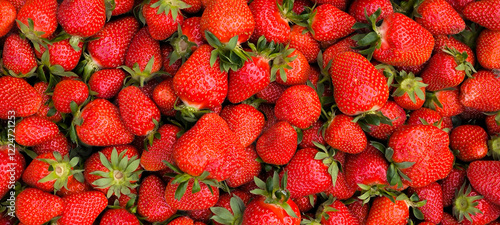 pile of ripe strawberries in the wooden box