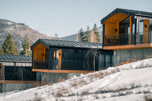 Obraz na plátně Modern mountain cabins surrounded by snow-covered landscape in winter
