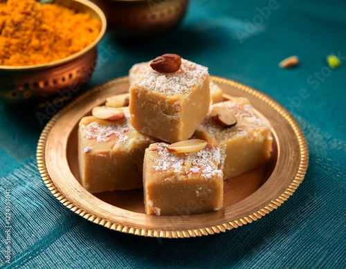 Rava barfi or sooji burfi or barfee is an Indian Sweet made with semolina, sugar, ghee and almonds photo