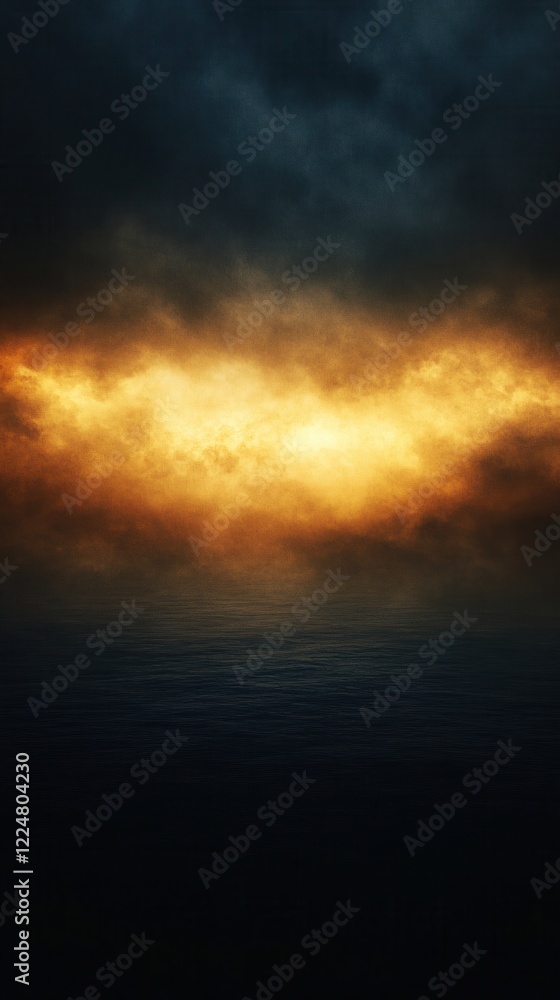 Obraz premium Dramatic sky over dark water with golden light creating a moody and abstract landscape