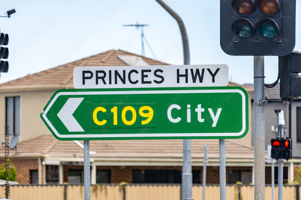 A road sign directs drivers towards Melbourne city via Princes Highway C109, indicating a major thoroughfare and freeway in Australia. A road sign directs drivers towards Melbourne city via Princes Highway C109, indicating a major thoroughfare and freeway in Australia.