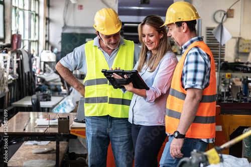 	
A supervisor stands confidently with workers on the factory line, using a tablet to check the numbers and quality of production.	
