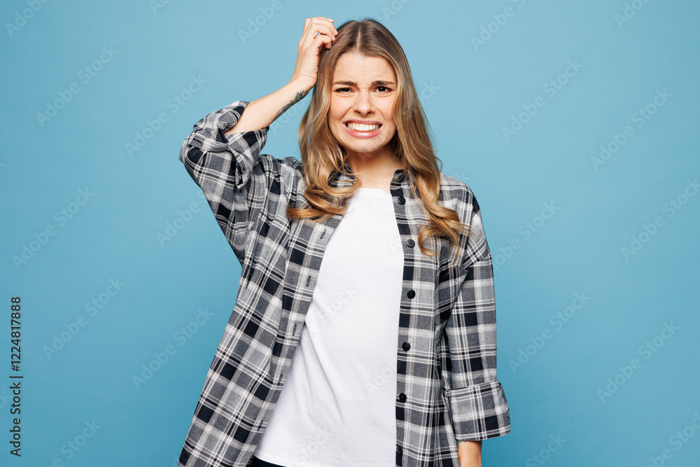Young sad dissatisfied woman wears checkered grey shirt casual clothes put hand on head scratch it look camera isolated on plain pastel light blue cyan background studio portrait. Lifestyle concept. Young sad dissatisfied woman wears checkered grey shirt casual clothes put hand on head scratch it look camera isolated on plain pastel light blue cyan background studio portrait. Lifestyle concept.