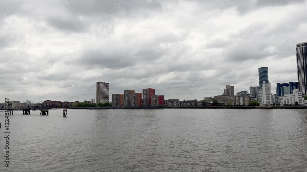Thames river and many modern buildings in London. It is a view from Greenwich area. Thames river and many modern buildings in London. It is a view from Greenwich area.