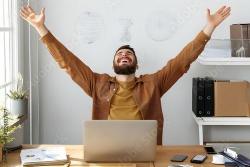 Excited Businessman Raises ...