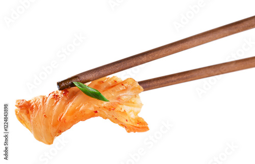 Chopsticks holding kimchi cabbage on white background. Hot fermented napa cabbage.