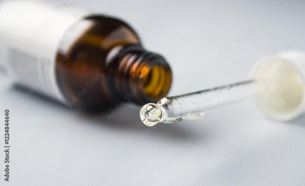 Pipette and facial serum close-up on gray background Pipette and facial serum close-up on gray background