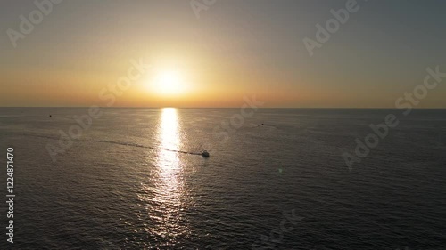 Yacht at sea during sunset drone view
