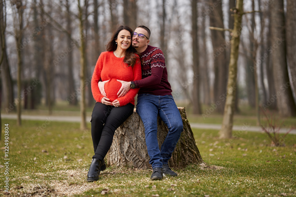 Fototapeta premium Expecting couple embracing outdoors