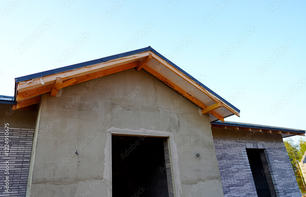 Roof Construction of Unfinished Suburb House. Suburb House construction. New house under construction in suburban neighborhood. Wooden framework of roof home. Roof installation, roofing works. Roof Construction of Unfinished Suburb House. Suburb House construction. New house under construction in suburban neighborhood. Wooden framework of roof home. Roof installation, roofing works.