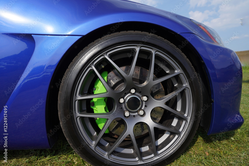 Alloy wheel with calipers and racing brakes of the sport car. Racing brake disc and low profile tyres. Race car test driving. Lower-profile tires of drag and drift cars. High-performance sports cars. Alloy wheel with calipers and racing brakes of the sport car. Racing brake disc and low profile tyres. Race car test driving. Lower-profile tires of drag and drift cars. High-performance sports cars.