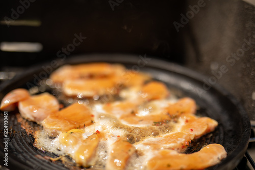 Chicken sizzling in a pan r...