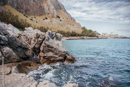 Waves Crashing Against Rocky Coastline in Italy photo