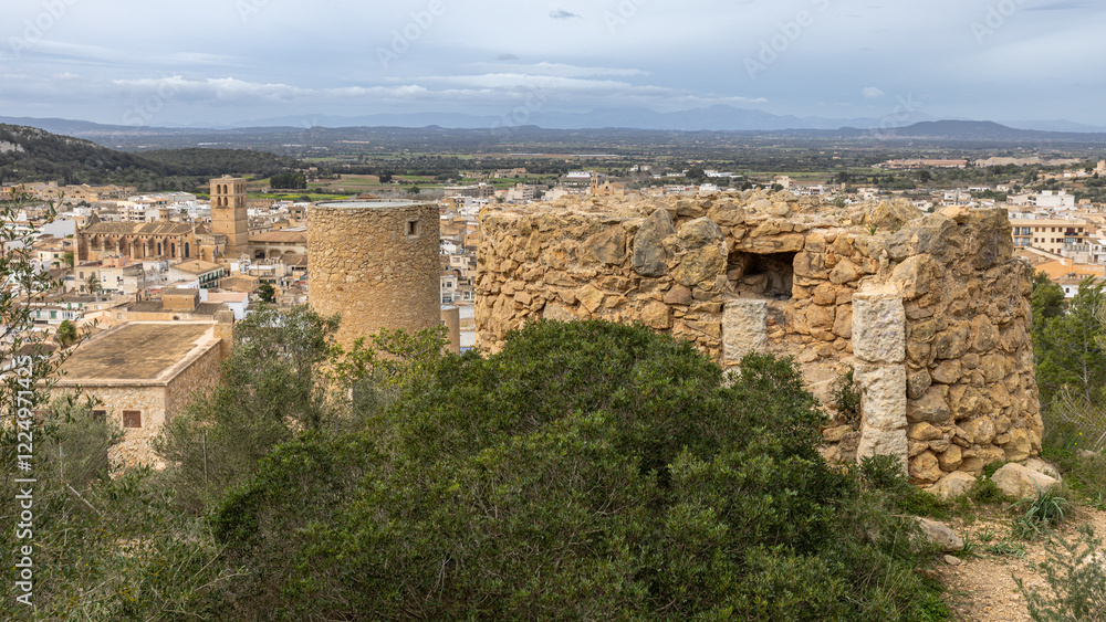 Fototapeta premium Remains of the old windmill Moli d'en Xeta and behind it the restored mill tower Moli d'en Veny above Felanitx, Mallorca, Balearic Islands, Spain