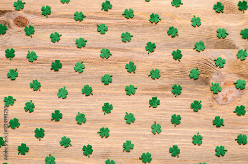 St Patricks Day background with green quatrefoils on the wooden background photo