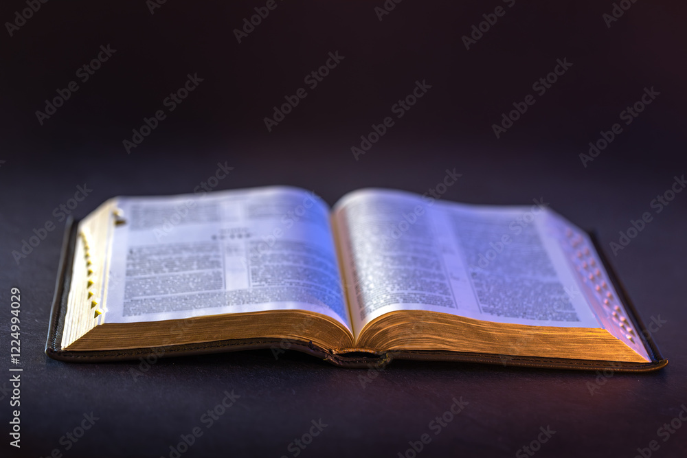 Open Holy Bible on the table. Religion concept. Bible on black background. Open Holy Bible on the table. Religion concept. Bible on black background.