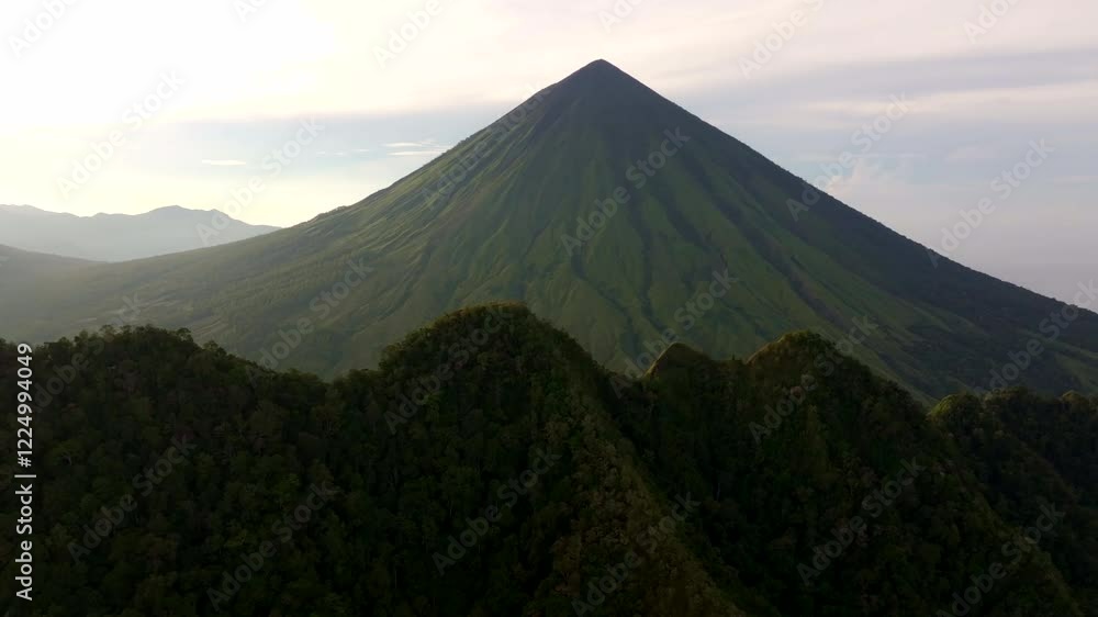 Aerial view of mountain with muted tones of greys, greens, and browns, evoking a feeling of serenity and natural beauty. Aerial view of mountain with muted tones of greys, greens, and browns, evoking a feeling of serenity and natural beauty.