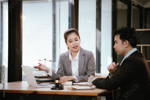 Lawyer Legal counsel presents to the client a signed contract with gavel and legal law. justice and lawyer Business partnership meeting concept.