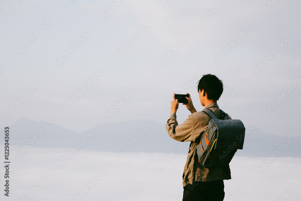 © doidam10 - Man traveler with camera backpack hiking outdoor travel lifestyle and adventure concept. cap backpack and join of tourist for green mountain tour, beauty of nature and expansive sky people of tourism