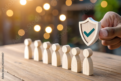 Insurance salesman holding shield symbol with businessman employee model concept of group insurance provided by company to employees
