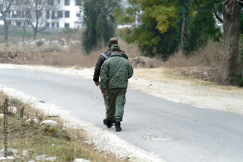 Army officer walking the road photo