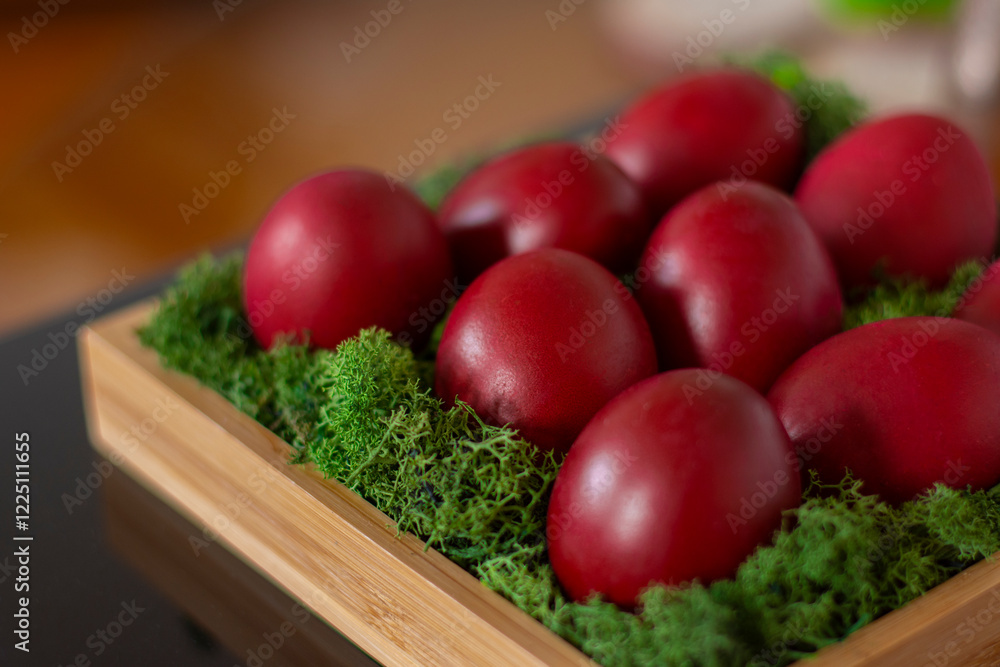 Bright red Easter eggs in a moss nest Bright red Easter eggs in a moss nest