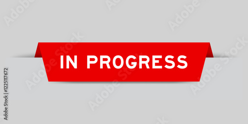 Red color inserted label with word in progress on gray background